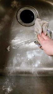 Tired of a dirty looking sink? Learn how to make your own DIY kitchen sink cleaner for your stainless steel sink or white porcelain sink. These cleaning tips using baking soda, lemon, and essential oils make quick work of stuck on messes. Learn how to clean a stainless steel sink with your own homemade sink cleaning scrub. Click to get your sink cleaning hacks and get a clean sink again! @naturalsoapmom.com #sinkcleaner #kitchencleaning #kitchencleaningkits #kitchencleaner #sinkscrub #kitchensinkclean #cleankitchen #cleankitchenatnight #cleankitchens #sinkcleaning #cleankitchens #dirtysink #dirtysinks #stainedsink #allnatural #sanitize