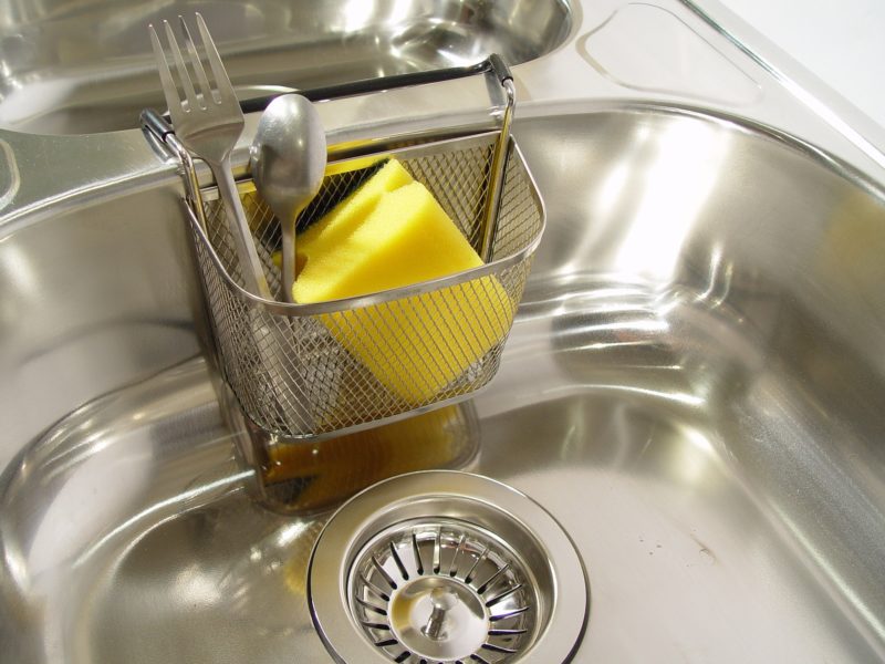 Tired of a dirty looking sink? Learn how to make your own DIY kitchen sink cleaner for your stainless steel sink or white porcelain sink. These cleaning tips using baking soda, lemon, and essential oils make quick work of stuck on messes. Learn how to clean a stainless steel sink with your own homemade sink cleaning scrub. Click to get your sink cleaning hacks and get a clean sink again! @naturalsoapmom.com #sinkcleaner #kitchencleaning #kitchencleaningkits #kitchencleaner #sinkscrub #kitchensinkclean #cleankitchen #cleankitchenatnight #cleankitchens #sinkcleaning #cleankitchens #dirtysink #dirtysinks #stainedsink #allnatural #sanitize